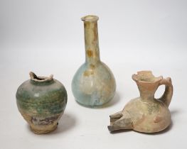 A Roman glass vessel, an Islamic pot and oil lamp, largest 18cm high (3)