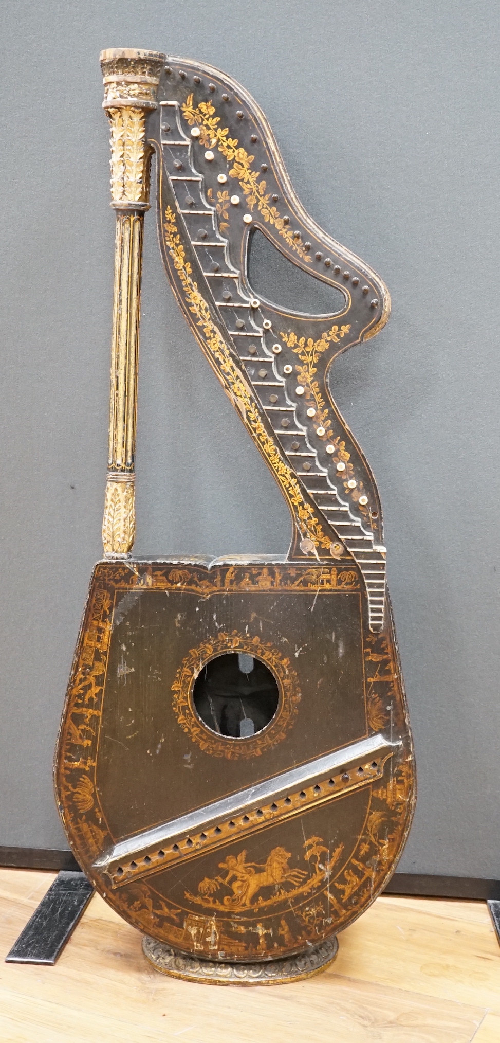 A Georgian parcel gilt and ebonised harp-lute by Edward Light, with fluted pillar, Royal coat of