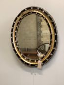 A small 19th century Irish oval wall mirror, with twin faceted and cabochon glass border, width