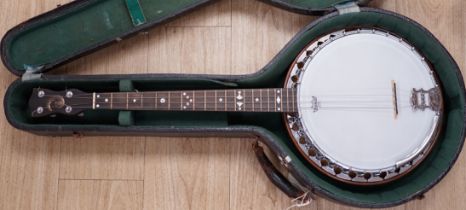 A cased English 1930s Windsor Whirl four string tenor banjo, mother of pearl inlaid neck, length