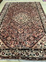 A Hussein Abad brick red ground carpet, 322 x 202cm