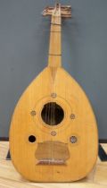 A Middle Eastern eleven string lute, overall length 82cm
