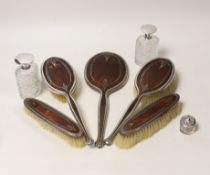 A George V silver and tortoiseshell pique mounted dressing table set, Adie Bros, Birmingham, 1934,