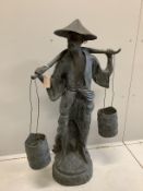 A Chinese style bronze garden ornament modelled as a water carrier, height 102cm