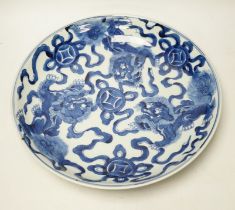 A Chinese blue and white ‘Buddhist lion’ dish, channel moulded foot, 36cm diameter