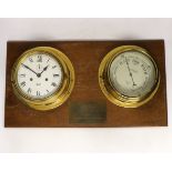 A brass mounted barometer and bulkhead clock with presentation plaque, 56cm wide