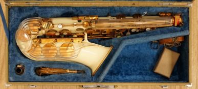 A cased Grafton alto saxophone with cream plastic body and brass plated key work, serial number