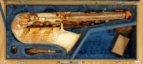 A cased Grafton alto saxophone with cream plastic body and brass plated key work, serial number