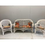 A vintage wicker three piece conservatory suite with Kilim style printed fabric cushions, settee