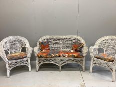 A vintage wicker three piece conservatory suite with Kilim style printed fabric cushions, settee
