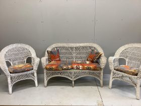 A vintage wicker three piece conservatory suite with Kilim style printed fabric cushions, settee