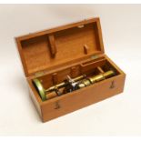 A brass monocular student’s microscope in fitted teak case, case 22cm