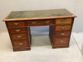 A late Victorian mahogany kneehole writing table, fitted nine small drawers, width 130cm, depth