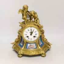 A French gilt metal enamel mantel clock surmounted with two cherubs, 30cm high