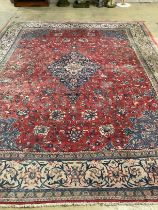 A Persian brick red ground carpet, 382 x 300cm (severely worn in patches)