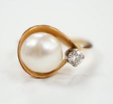 A yellow metal , single stone cultured pearl and single stone diamond set ring, size J, gross weight