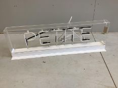A neon 'Petite' illuminated shop sign, width 115cm, height 35cm ( in full working order, PAT tested)