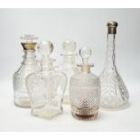 Two silver mounted glass decanters, a pair of waisted cut glass decanters and one other, tallest