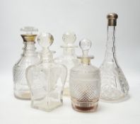 Two silver mounted glass decanters, a pair of waisted cut glass decanters and one other, tallest