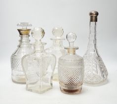 Two silver mounted glass decanters, a pair of waisted cut glass decanters and one other, tallest