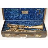 An early 20th century cased Boosey & Hawkes clarinet with plated metal body, bell engraved with ‘