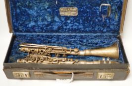 An early 20th century cased Boosey & Hawkes clarinet with plated metal body, bell engraved with ‘