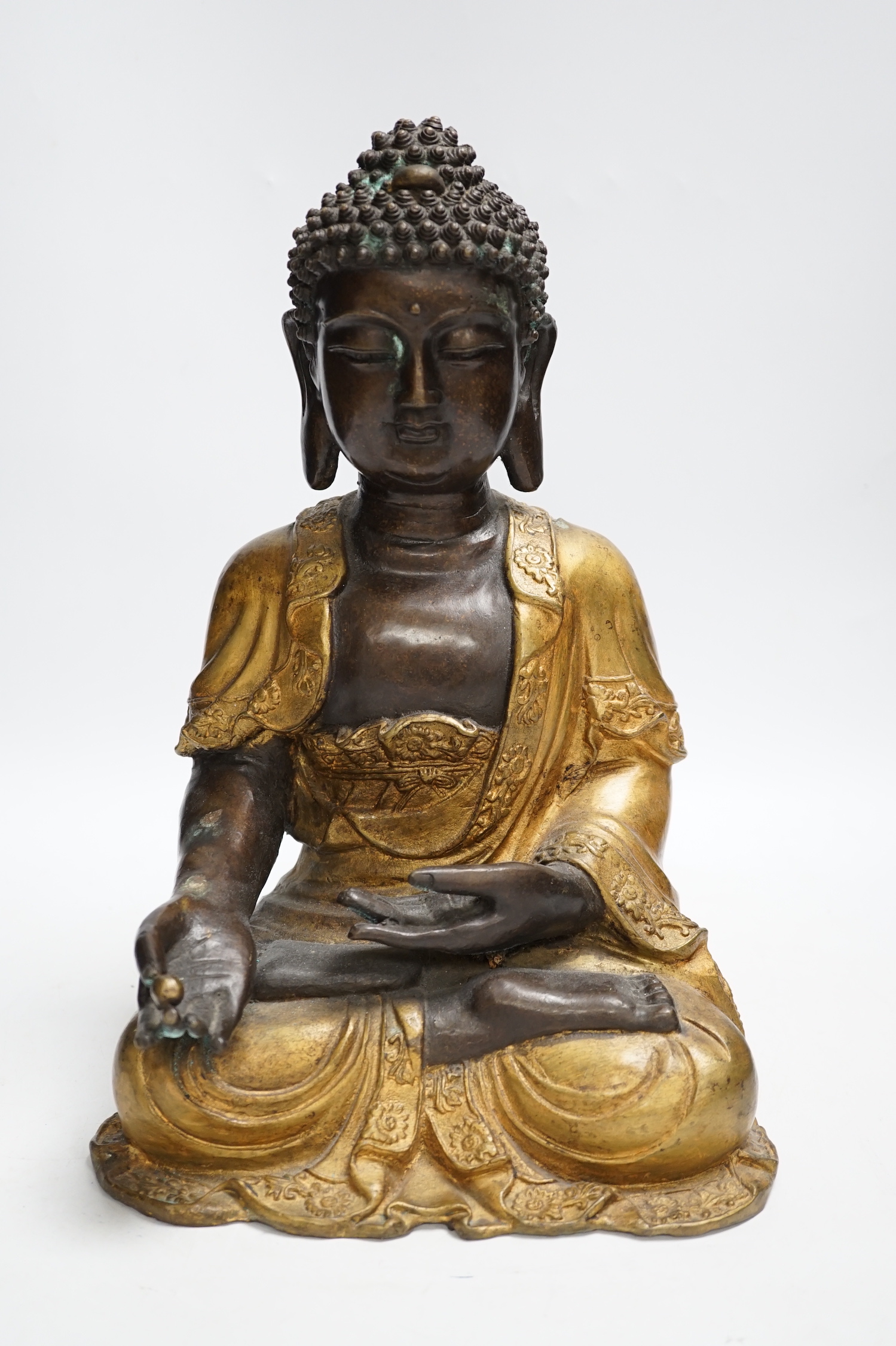 A gilt bronze seated Buddha, 35cm high