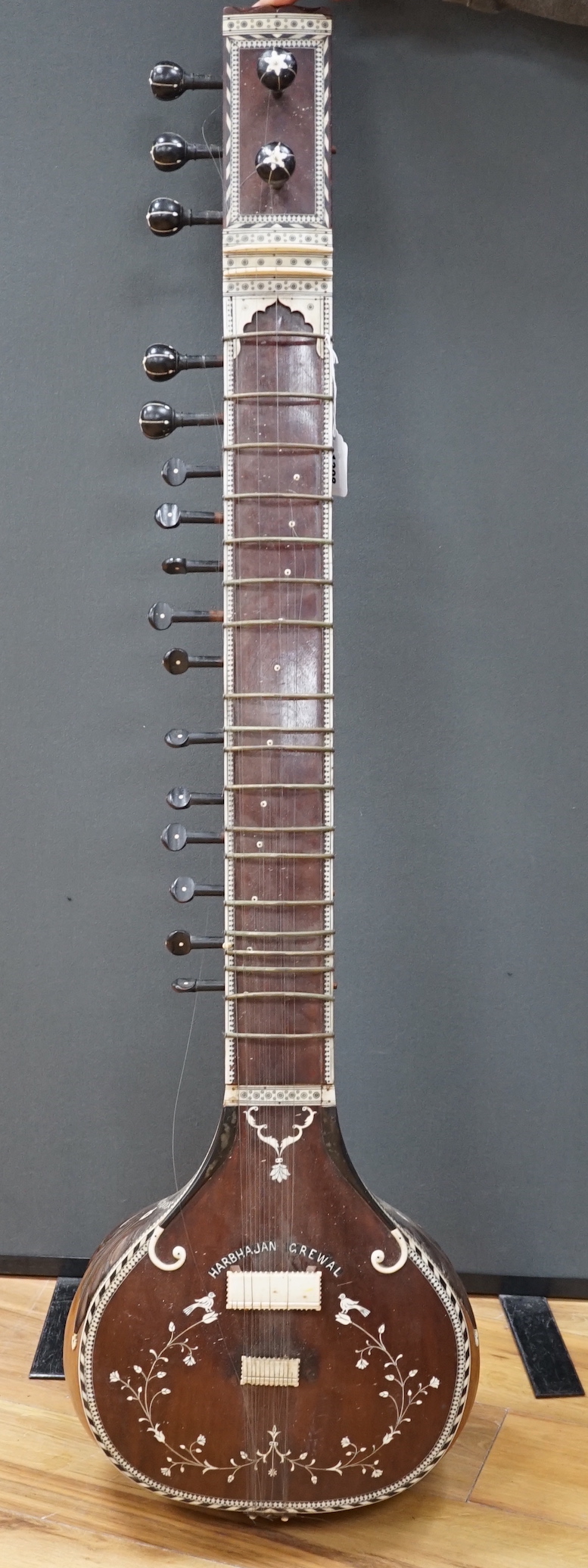 An Indian sitar, with ivory bridge and decoration, inlaid with ‘Harbhajan Grewal’ overall length