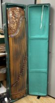 A cased Chinese Guzheng zither harp, hardwood body with blind fretwork decorative panel of birds and