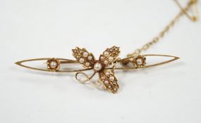 An Edwardian yellow metal and seed pearl set bar brooch, 50mm, gross weight 3 grams.