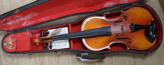 A cased Czechoslovakian student’s violin with Stradivarius label, length of body, 35.5cm, with spare