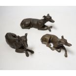 Three late 19th century bronze models of recumbent greyhounds, 17cm