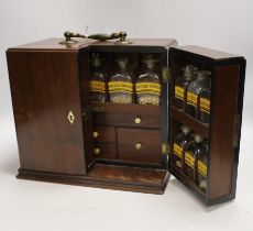 A Georgian mahogany domestic medicine chest, with bone drawer knobs and escutcheons, containing a