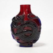 A Chinese amethyst and ruby glass ‘dragon’ snuff bottle, 19th century, 6cm high