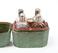 A set of four Dutch white metal mounted scent bottles, with funnel, housed in a shagreen case with