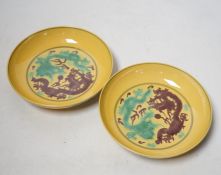 A pair of Chinese yellow glazed ‘dragon’ dishes, 13cm in diameter