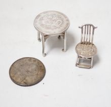 A Chinese Republic period one dollar 1920, and two Chinese Guangxu period coins mounted as miniature