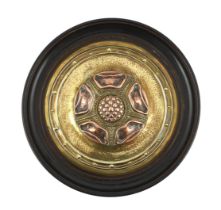 An Arts and Crafts brass and copper roundel, in the manner of Archibald Knox, monogrammed CA,