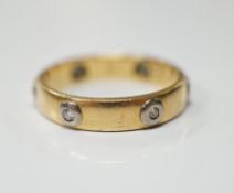 A modern Cartier 18ct gold and six stone diamond set band, signed and numbered 441404, size L, gross