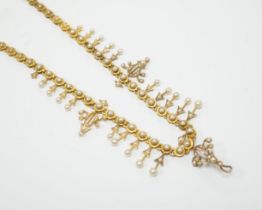 An Edwardian yellow metal and seed pearl set necklace, lacking drops and clasp, 39cm, gross weight