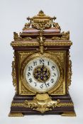 A French oak and brass mounted mantel clock with enamel dial, 42cm high