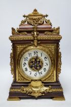 A French oak and brass mounted mantel clock with enamel dial, 42cm high