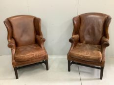 A pair of George III style studded tan leather wing armchairs, width 74cm, depth 84cm, height 112cm