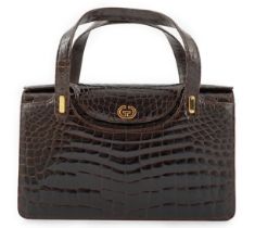 A lady's vintage brown crocodile handbag with gilt metalware.Please note that this American