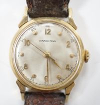 A gentleman's 14k Hamilton manual wind wrist watch, with Arabic dial, on associated leather strap.