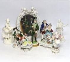 Seven Continental porcelain figures and an oval mirror with floral encrusted decoration, 27cm high