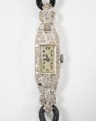 A lady's white metal (engraved platinum) and diamond cluster set manual wind cocktail watch, on a