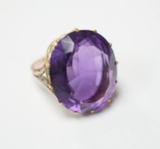 A yellow metal and oval cut amethyst set dress ring, with diamond chip set shoulders, size O,