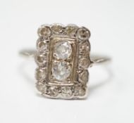 An early 20th century white metal and diamond cluster set tablet ring, size P/Q, gross weight 2.2