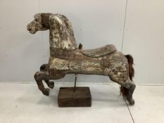 A vintage metal bound carved wood carousel fairground horse with traces of original paint, length